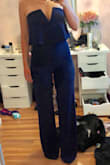 The fabric is thick and not see-through, but it's cheap and would probably look more expensive in black. The jumpsuit is also super long. I'm 5'2 and the legs are too long even in stilettos. Definitely go a size down. For myself it recommends a small, but I got xs and is fits well. The material is also stretchy which is nice so it hugs all my curves without suffocating me. - Catherine H.