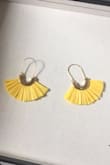 Looked exactly like the picture. Really cute and easy to wear. Definitely recommend. The material of the yellow fans is more straw-like rather than string or fabric. Included pictures to show what I mean and to give a size reference. Still super cute! - Madeleine O.