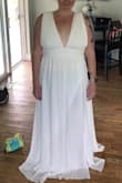 I plan to wear this for my vow renewal in Jamaica. It's absolutely beautiful! The material is a perfect wedding dress material. It's well made, not cheap looking or feeling, good quality dress. It has absolutely no stretch or give. The color is a true white, it has three layers in the dress. I am in love with it. The side slit is an added touch that I love as well. I do have to get it altered though, I need it shortened and let out in the waist or material added to the shoulders so it can fit my natural waist rather than my rib cage. I am at the top end of the measurement scale for the XL and it was too tight in the waist/rib cage, I couldn't zip it unless I let the straps fall down off my shoulders and pulled the dress to my natural waist. For reference, I wear size 14 pants and a Large shirt. I can't wait to wear this on my -I do take 2 day!! I'll feel like a beautiful Queen! - Alesia T.