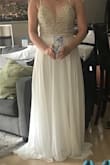 The dress fits great and was very comfortable. The beading on top is beautiful, but not as white as I expected from the photos. The top is also very sheer. It is a beautiful dress, but not quite what I was hoping for. I'm going to return it. - Alicia R.