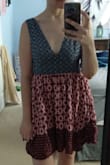 A lot of people said that this was super low cut and showed too much, but I was wishing for more cleavage! It's a great dress ! Super boho. Super cute. Extra lined and very durable/flowy material. LOVE. - Mikki B.