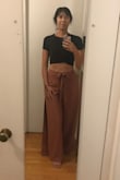Although I have wide shoulders, the medium still fit well even though I probably could have gone up to large. Showed decent amount of stomach but could be covered enough with the right high waisted pants. The shirt is slightly lower/more modest from the back. Happy with the unique wrap design on midriff. - Amy L.