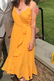 I wore this for a summer wedding and got so many compliments on the color. I bought the earrings the model wore for a perfect match, as well. It is a true wrap dress, which was a little difficult to situate at first, but it stayed tied all night and didn't slip at all. Nice and flowy, but it's also structured at the chest so it wouldn't slip. - Rebecca N.