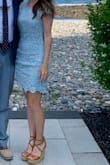 This dress is gorgeous and I love the light blue. I recently wore this to a wedding and got so many compliments! It's a great cocktail dress and the open back makes it a lot of fun. It is a bit large up top but I am technically XS on top (30D bra size) and a small in the hip/thigh area. It worked just fine and isn't really alterable on top. An XS would have been too tight in the hip/thigh area for me. - Clara E.