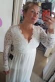 I normally wear a 12/14. I can fit into some mediums, larges and extra larges. We all know it depends on the brands. I hope this review helps someone who has the same built as me. I have gained some weight (I am in 16s now), so I really should have ordered an XL according to their size chart. I went with the large and I'm shocked on how well it fit me. The waist line is tight and I have about two or three inches to lose to be able to clasp the back comfortably. (I am able to clasp it, but my back rolls roll over the dress lol) It's a beautiful dress, and I'm so happy I purchased it! - Kristen O.
