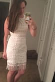 I love this dress! Purchased it for my bridal shower and am so glad I did. I was pleasantly surprised when I tried it on because it's a lot more soft and stretchy than pictured. I was thinking it was stiff and not form fitting from photos and reviews, but that's not the case at all. The bottom string/fabric pieces will for sure need to be ironed, but that's not a big deal. Overall, this was a great buy! - Morgan C.