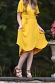 This dress was so cute! I wore it for my engagement photos. It is a wrap dress so just be sure it tie it correctly to avoid any mishaps. I am about 5'1" and 110 lbs with a small chest and the XS fit perfectly. It hit around my knee which was perfect for what I was looking for. - Kayla W.