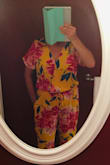 I've been trying on a lot of summer rompers in department stores and never seemed to find one I liked mostly because the fit was always weird. I bought this one on a whim because it was on clearance. I love it! It fits perfect. I love the deep yellow color. Although, it's a brightly patterned material, it looks very classy. The only thing about it that I have issue with is (1) it has a blouson wrap top with a hook closure at the top. However, it wants to open at bottom. I'm going to do something to keep it closed. And (2) I wish the pattern lined up a little differently on the legs. It's me being a little nit-picky. There are 2 big flowers that line up across from each other on each line, which cut off how the length of your legs look. - Kelly C.