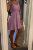 Stated runs large because all Lulus dresses run large to me. I'm typically a medium in all other brands except for this one for whatever reason, I'm a small. I bought the lavender color on a whim because it was on sale. It turned out to be a very lovely color. The dress is quite simple but the ruffle and ties make it a darling little dress. The material is not my favorite, that rough/sheer/wrinkly fabric, but good quality and not see through. I haven't worn it yet but I'm sure its going to be very wrinkle-prone. But overall its a sweet little dress in a very unique color. - Samantha Z.