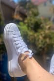 I loved these shoes so much, I bought about 8 different outfits to wear with them. Not to mention, they go with everything in my closet already. It's a good shoe to sport up an outfit, or make it casual. These with a mini dress are the perfect combo. They are WHITE so I suggest buying a water and stain repellent spray to use on them before wearing them. I'm a true 8 and they slip off my feet if I'm not wearing socks. Might try some sock free saviors to fill up the space without compromising my look. Would highly recommend! - Alison C.