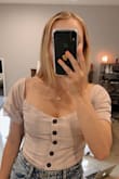 I love this top. super cute and flattering however it's very tight in the chest. I wear a 34B/C depending on where I buy from and this top is very tight in that area. the buttons slightly gape. I'm still going to keep it and try to make it work because the pattern and everything is so cute but I'd recommend sizing up if you have boobs similar to mine or larger. - Emma D.