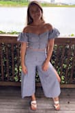 The pants were a little long and I had to get them hemmed. Aside from that, the outfit is beautiful and flattering with the high-waisted pants. - Nicole P.