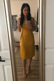 I'm so glad I ordered this dress. I wore it to my brother's wedding and received many compliments on it (the color is amazing!). I am a standard M and a size 6 in almost everything and this M fit well. It felt slightly loose so I thought maybe a small would have been fine also, but I loved the way the M draped and didn't look too tight or risque. I was actually even able to go without a bra because the fabric is so nice and concealed well, which was amazing for the 95 degree weather. The tie at the waist was great also because you can customize the fit and really cinch it in. I felt trendy but classy and glamorous and would highly recommend this dress! Give it a shot, you won't be disappointed! - Taryn J.