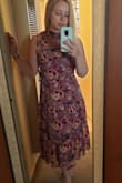 I love the high neck, the midi length, and the flowing material. It looks like it does on the model. But it almost offers so much coverage that it buries the shape of your body if that makes sense. I tried it with a belt and that helps a little. I plan to wear it to a wedding because it is so tasteful I feel like I wont have to worry about any slips or it riding up or anything like that. It's a little large in the neck area on me. Overall though, it's a nice addition to my closet! - Lindsey U.