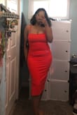 The color is an orange red I wore it for graduation and I was comfortable the whole time. Material has a bit of a give and is soft. I had to wear it to photo shoots as well and after 2-3 times it got a small whole under the zipper but I was able to sew it back up. - Jovanny P.