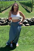 This skirt is super cute and comfortable. It's very flowy so it's a perfect summer skirt. Dress it up with wedges. I paired it with a little white cropped top and sandals to wear to a winery for the day. It was the perfect little outfit to transition from day to night. 
It's a bit long in the back on me since I'm short. And the material wrinkles very easily so either go with the wrinkles or you'll definitely need to iron it every time you wash it or travel with it. - Jennifer S.