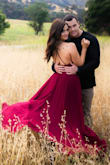 I ordered the dress in my normal size (small) and 1 size up because I read reviews of it running small. The small was just a little tight and the medium was a bit too big but I ended up going with the medium for our engagement photos and just having it tailored a little. The pictures turned out perfect, and I've gotten so many compliments on the dress. The fabric is heavy and doesn't snag, I had plants stuck into the fabric after the shoot and you could even tell once they were pulled out. - Jordan C.