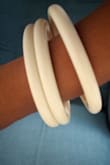 The Bangles are lovely and so versatile. But, they are not even close to being white. My set is an ivory, off whitish color. I was looking for a true white one. They appear white on the model. Luckily I can use them, but I'm still in need of a true white bracelet. - Arondia C.