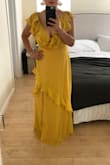 I am a bridesmaid in a wedding and needed to find an affordable and flattering long yellow dress. I thought it'd be very difficult to find the right fit, length and style. This is the first dress I ordered or even tried on and it's perfect!!! I ordered both a Medium and Large because I wasn't sure which would fit me best. I kept the Medium as it was ideal for me. On me the Medium could use a little hemming to shorten it by about 2 inches. I want to wear it with a heel and it's still long. It does have an open v-neck which I will have a tailer also put a closure on it for me. Such a great dress for such a great price! - Bethany N.