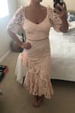 Love this dress in the stock photo but it looked just a bit strange on. The shoulders puffed up and would have to be tailored. Couldn't put my arms above my head. Usually between XS-S, could have gotten away with an XS but wouldn't have been able to move. - Amanda B.