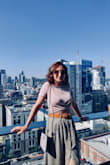 I like my skirts to cover my belly button, so I think I would've probably bought a size smaller, but with a belt it's perfect! It hits just below my belly button. The material is more on the heavier side, but I've worn it out on very hot days and it doesn't sweat through, plus it's breezy! I love that you can button/unbutton it as much as you want. - Nyvi L.