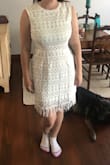 I originally bought this dress for my bridal shower. It looks stark white in the photos but the lining is definitely more of a cream color. It was cute but a little big on me. I could've worn it to my bridal shower but decided to return it and find another dress that fit better. - Emily G.