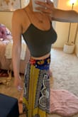I loved this little tank! It's very comfy and stretchy. The M/L felt a little loose, but definitely not too loose to need to return the size. I wonder how the smaller size compares? - Samantha O.