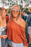 This shirt is super cute and has give to it! It fits true to size but if you were between sizing up or down, I would say size down as it is on the larger side if anything. It hits me shorter but it is super cute!! - Cara C.