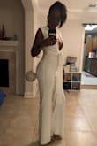 I bought this for my all white birthday party and it was perfect. It was a little tighter in the thighs area than I would like but I wouldn't have gone up a size because of it. Definitely felt like a model all night and received so many compliments. I actually tied mine in the front instead of the back. - Batney T.