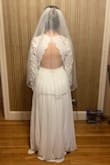 I originally ordered a Small and loved the style. The dress has a good weight to it and the sleeves are more crochet than lace, but it's very comfortable and just bridal enough for my more casual taste. The small was too long, the sleeves were too wide, and the bust was very loose so I decided to exchange for an XS. It's still not a perfect fit, but I'm planning on getting it hemmed and the sleeves/bust tightened. I also feel like the scallops on the neckline look a little "matronly" on me, so I'm planning to get them removed/sewn folded over like in the photo. Can't wait to wear this for my outdoor Maine wedding next October! - Meghan C.