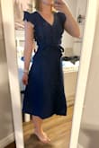 I think this dress is very cute, but honestly I don't think I would have bought it if it wasn't on sale. The ruffles are a bit big for my taste, and the fit is quite long, but the XS does fit very nicely in the waist and chest. I think once I hem this dress about 4-6 inches it will look a lot more proportional. The fabric feels of good quality.

Overall, it is not perfect, but with a few adjustments, it will make a great work dress. I think this style is a bit overwhelming on a petite frame, but would probably look fabulous on taller gals! - Makenna M.
