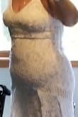 This dress is gorgeous. It is a heavy material and lace. I have a muffin top though and it accentuates it. I ordered a large. I returned it and waiting for the extra large to see if that makes a difference. It's very comfortable and doesn't wrinkle. Would be great to take in a suitcase on a destination wedding. Worth it for the person with the right figure. This dress is beautiful. - Tracy S.