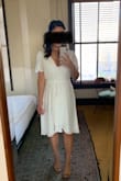 This dress fits true to size and is flattering for petite girls because it has the waist tie. I wore a white bra that acted as a camisole so that if my bra showed it didn't look bad. Was getting compliments all day! - Erica E.