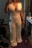 This jumpsuit is perfect for my bachelorette party in San Diego next month. The white fabric is thick and not see-through at all. It's boob-y, but tasteful and will definitely keep the girls in well thanks to the crisscrossed back. It will definitely need to be hemmed; I don't think I've ever worn something so long before. The back is stretchy-no zipper. That part on me could probably be tighter, and the hip and thigh region could be looser, but it's fine. It will be great! - Caitlyn N.