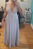 I'm pleasantly surprised with how well this dress fits. It's the perfect length, and the material is super nice. There are 3 layers- 2 flowy chiffon (??) layers, and the innermost one that's kinda heavy and is a little bit shorter and has a curved hem (I'm having it shortened as much as possible because I'm wearing it for a beach wedding in Punta Cana, and want to make it as lightweight as possible). The slit does go pretty high, but I like it!
I'm having a tailor shorten the straps as the bust area was pretty loose (and I dont have a small chest). That being said, if I wasnt wearing it as part of a bridal party, I couldve made do and pulled it down on my body to tighten the over the shoulder pieces (like I'm doing in the photo) and use some tape to keep everything where it should be.
I ordered the light grey and its exactly as shown in the photo.
Overall super great dress! - Robyn M.