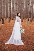 I spent months agonizing over spending an arm and a leg on a wedding dress... until I stumbled across this one! I fell in love with a friend's picture on FB in which she wore this dress in navy as a bridesmaid in another wedding. Immediately after she told me where she got it from, I went directly to the site and took my measurements and ordered a Medium. Fast shipping and perfect condition, it fit like a glove! I did need to have it hemmed because it was a bit long. I was prepared for this because I had read other reviews! It worked out because I wanted to wear flats for my wedding and I also wanted a "small" train so a very non drastic high-low hem did the trick.
This dress was PERFECT for my wedding day! It was super comfortable to wear the whole day and I got so many compliments on it. The details in this dress are amazing, especially for the price!! I love looking back on my wedding pictures because of how beautiful I felt in this dress. I joke that I want to dye it and wear it again, but I would even consider ordering a different color of this dress for future occasions! - Amanda M.