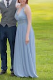 I ordered this to wear as a bridesmaid in my brother's wedding. The fit was alright, but it was a little big in the waist, leading to the dress falling away from my body and making me look heavier than I am. I didn't have time to order a smaller size though. I had the dress hemmed because as a 5'2 woman, there was about 5-7" of extra material dragging on the ground. I also added cups because the material was thin and showed my nipples.

This dress wrinkles terribly- I had to steam the dress because it arrived wrinkled, and by the end of the reception, it was wrinkled again.

But I did get a lot of compliments on the dress and it was comfortable to wear. The adjustable straps were nice too because I ended up adjusting them as tight as they could go.

I think I just needed a smaller size. - Anna J.