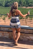 I love this romper and wore it on vacation in Barcelona to wine tasting (I knew I'd be outside and didn't want weird tan lines so the strapless was perfect!) 9 times out of 10 (or maybe even more), I'm a size small- at Lulus and elsewhere. I bought the small first and couldn't get the top to zip the last couple inches though the rest fit perfectly!! Then I bought the medium, which I kept and it fits on, but the bottomed/short part are a little longer and baggier than I wanted, and the seam at the waist line probably has about 1-2 inches of give/extra room, making it look less fitted. It zips now, but with more room than I needs - the inside has that rubbery stuff on it so helps it to stay up but I definitely found myself having to lift it up more often than I'd like. If i'd had the time, I'm not sure I would have kept it. - Katie L.
