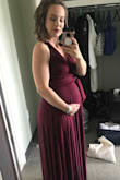 This fit so nicely on my 21 week bump and I'm confident it will fit postpartum as well. The fabric is so soft and very thick, so quite flattering. It was quite long for me, since I'm only 5'1", but with heels, it was perfect. - Emily D.