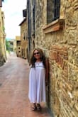 I bought this dress to wear on my trip to Italy this past summer.  It's very cute and comfy for the most part.  It was just a little tight up at the top and the little shiny squares bothered me, so I pulled some of them off.  It's also a little sheer too - even though it's lined, so I wore a skin colored panty and it was fine.  I wore it to work when I got back from vacation also and got lots of compliments.  It definitely helped keep me cool under the Tuscan sun! - Monique P.