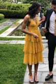 I got so many compliments on this dress. It has a fitted waist and adjustable straps that let you decide how it falls on you. Tighten them for smaller boobs, loosen them for bigger. All around a beautiful dress in a stand out color. - Maya O.