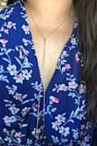 The necklace set comes with two necklaces. One is the long piece which is adjustable and looks nice. The other one is a small short necklace that has a very short chain that I cannot wrap around my neck without feeling like I'm being choked. My husband cannot even put it on me because the chain is too short. I'll only wear the long chain one. Too bad the other one didn't work out. I'm keeping it because it is too much work to return the set. I'm attaching the photo of the short chain in comparison with the yopait yogurt to show how short/small the chain is. - Angie W.