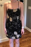 This dress is a black dress that is slightly shapely with a mesh overall that is not form fitting! The straps are too long and I was overall so disappointed with the fit. - Maggie C.