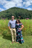 This dress is perfect if you are looking for something flowy yet flattering. I purchased this dress for our honeymoon, and wore it a second time to a friends wedding. I received so many compliments and it photographs so well with the vibrant colors. Due to my height, I did have to have it hemmed. The top is stretchy and ideal for girls who are busty like myself. The dress does have a slit but it is flattering and helps keep you cool on hot summer days. I highly recommend if you are looking for something comfortable and classy. - Amanda L.