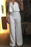 Absolutely in love with this jumpsuit! I plan to wear it to my rehearsal dinner. The White is not see through at all. Thick fabric. Don't need a bra either. Fits true to size. I'm 5'1 & as you can see I will definitely need a lot hemmed off (I am even wearing 4 inch heels in this picture & it's still really long) but I am used to this being so short. Debating on buying even more colors! Thank you LuLus! - Ashley C.