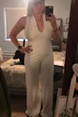 The jumpsuit looked great once I got it on but the back straps are hard to get adjusted to lay flat. I wish it had a zipper so I only had to adjust the top and not have to worry about taking the whole thing off to use the bathroom and then attempting to adjust the back straps every time. - Camille N.