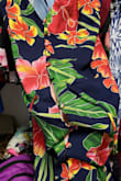 This is a great dress for a summer day or night or on a tropical vacation. The colors are gorgeous. I was surprised that the front buttons up but with more of a hook/loop and eye from the top all the way to the bottom of the hi-front, so there is a gap between the two sides coming together that has the potential to show quite a bit from. See picture with my hand underneath. A small slip sewn into the dress would fix it. It is loose enough on me that I can pull the belt tight to sort of overlay itself. I'm 5'10" 158 pound, 36B and bought a medium. - Felisia B.