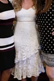 This dress was form fitting and classy, a perfect style for my bridal shower. I got so many compliments! I was a little unsure about the sleeves because they kind of bump up at the top like shoulder pads. Felt more awkward than it looked at first but didn't bother me after. It was very flattering on me but as other people have stated, material is not stretchy. - Cori T.