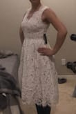 I bought this to wear during my wedding reception because my wedding dress is very restrictive and I wanted something pretty but simple to dance in. I must have a long torso, because I felt the waist of this dress hit too high on me. It flared away from my hips and made me look larger than I am. If the waist was a little lower, it would have looked better. Still would be a pretty dress on someone else. I sent it back. I did like that you can wear a regular bra with it. And the nude/blush lining was a good color for someone fair like me. - Ashley P.