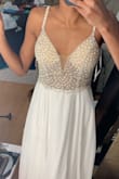 Sorry the photos are very blurry. I really love this dress, one of the beads wasn't on all the way, but I'm sure it's an easy fix! It's really long! I'm going to have to have it hemmed!
Other than that it's a really beautiful dress, I can not wait til next July for my wedding. - Erika K.